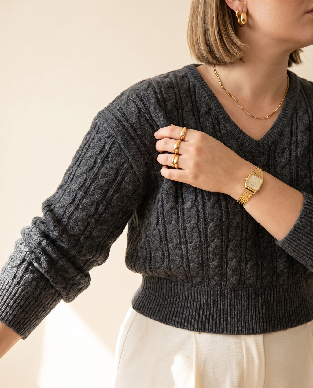 Cable V-Neck — knit detail, on a warm ivory studio backdrop