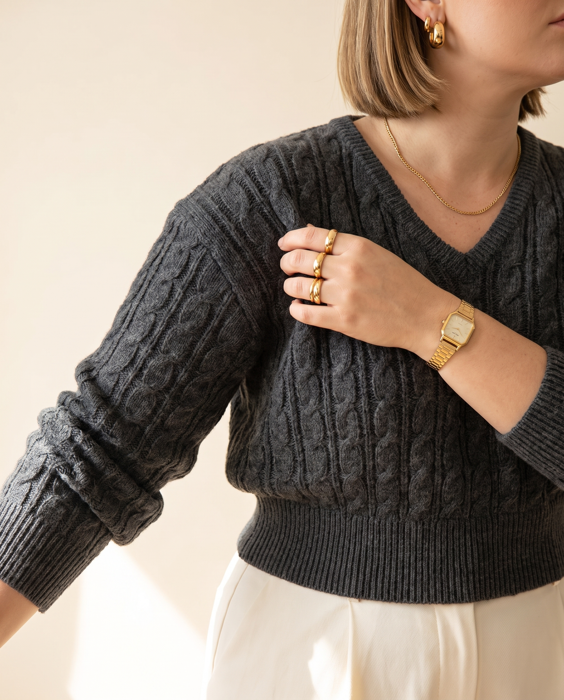 Cable V-Neck — knit detail, on a warm ivory studio backdrop