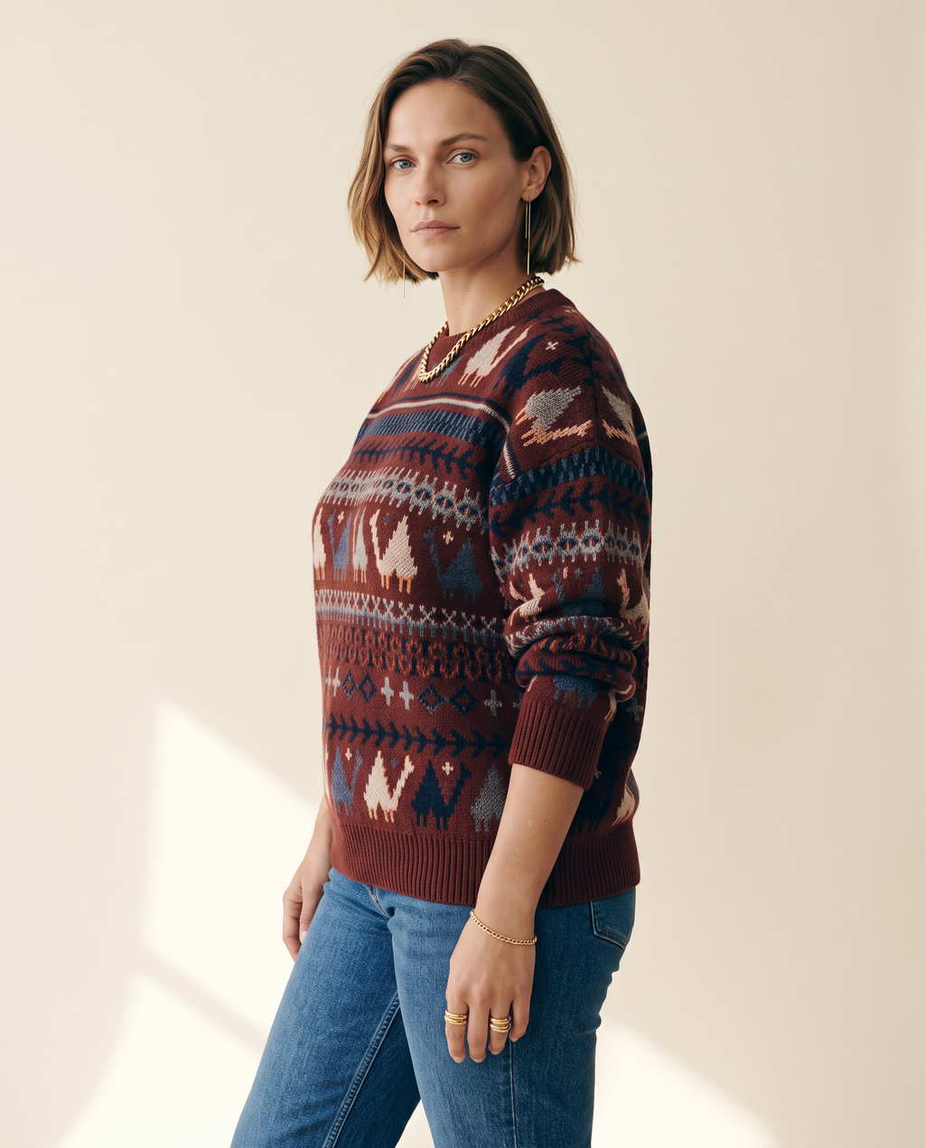 Folk Pattern Sweater — three-quarter view, on a warm ivory studio backdrop