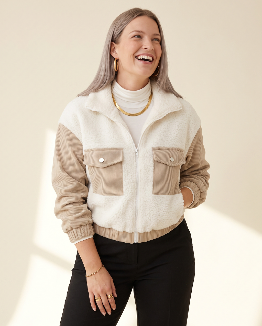 Teddy Panel Jacket — three-quarter view, on a warm ivory studio backdrop