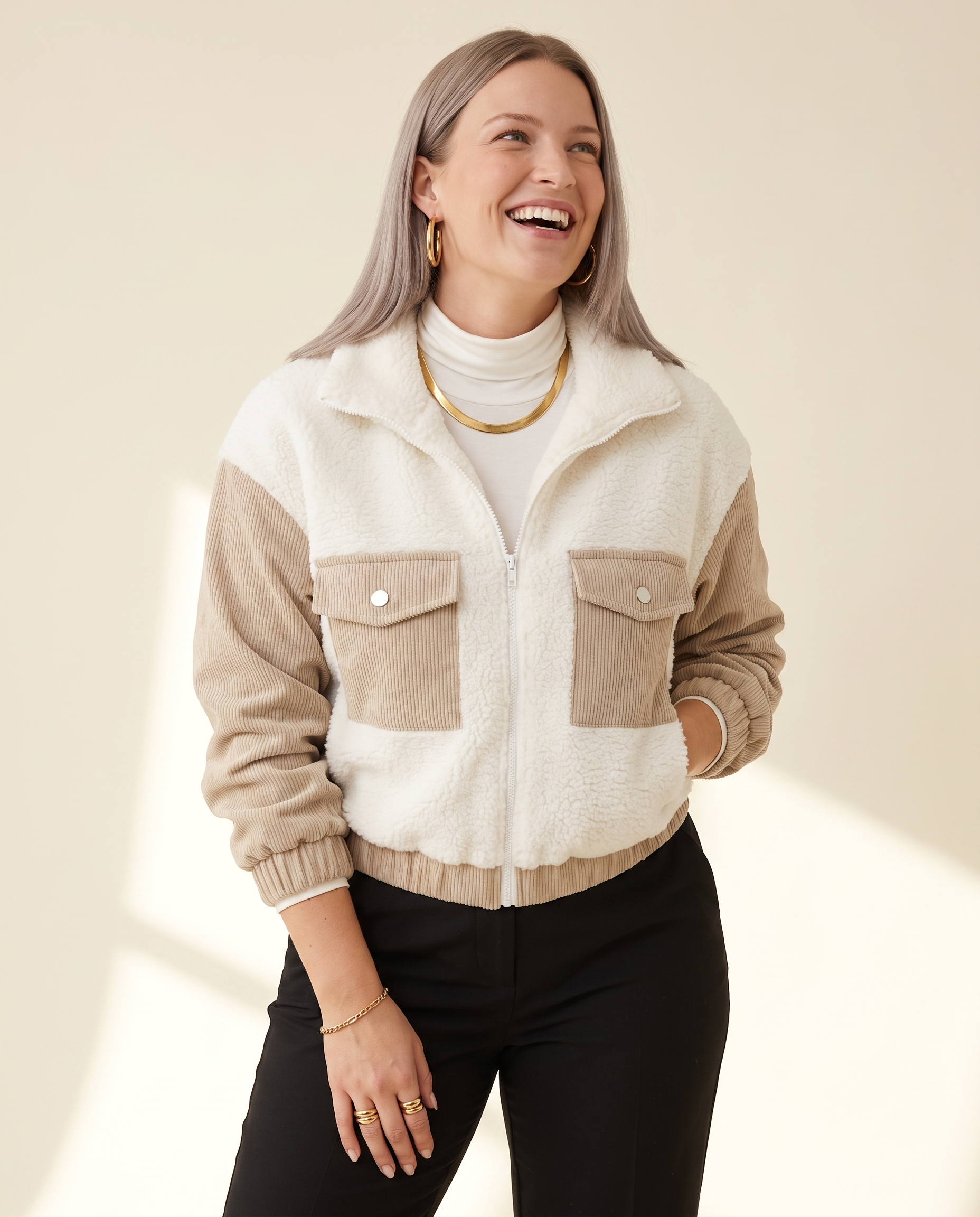 Teddy Panel Jacket — three-quarter view, on a warm ivory studio backdrop