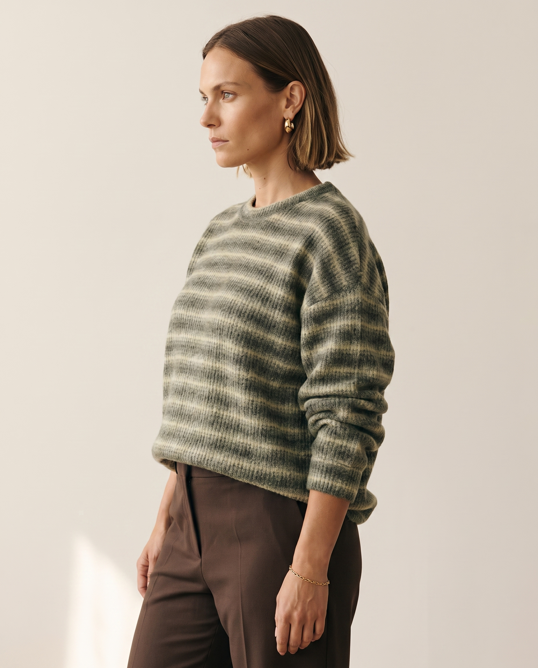 Soft Stripe Crewneck — three-quarter view, on a warm off-white studio backdrop