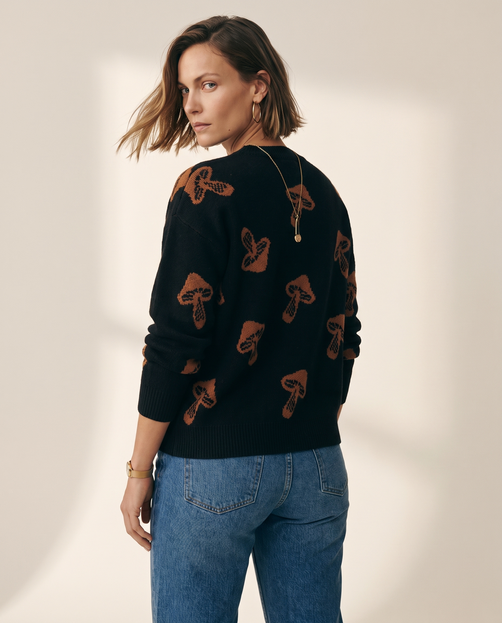 Jacquard Pullover — back view, on a warm off-white studio backdrop