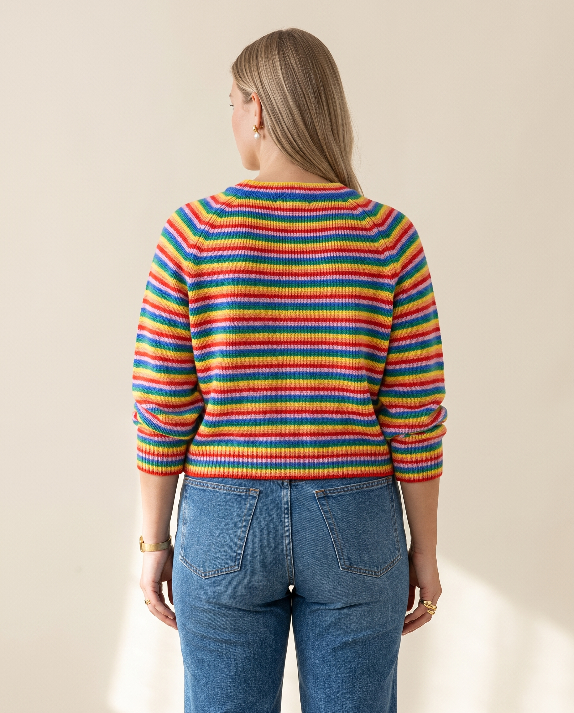 Rainbow Stripe Crewneck — back view, on a warm ivory studio backdrop