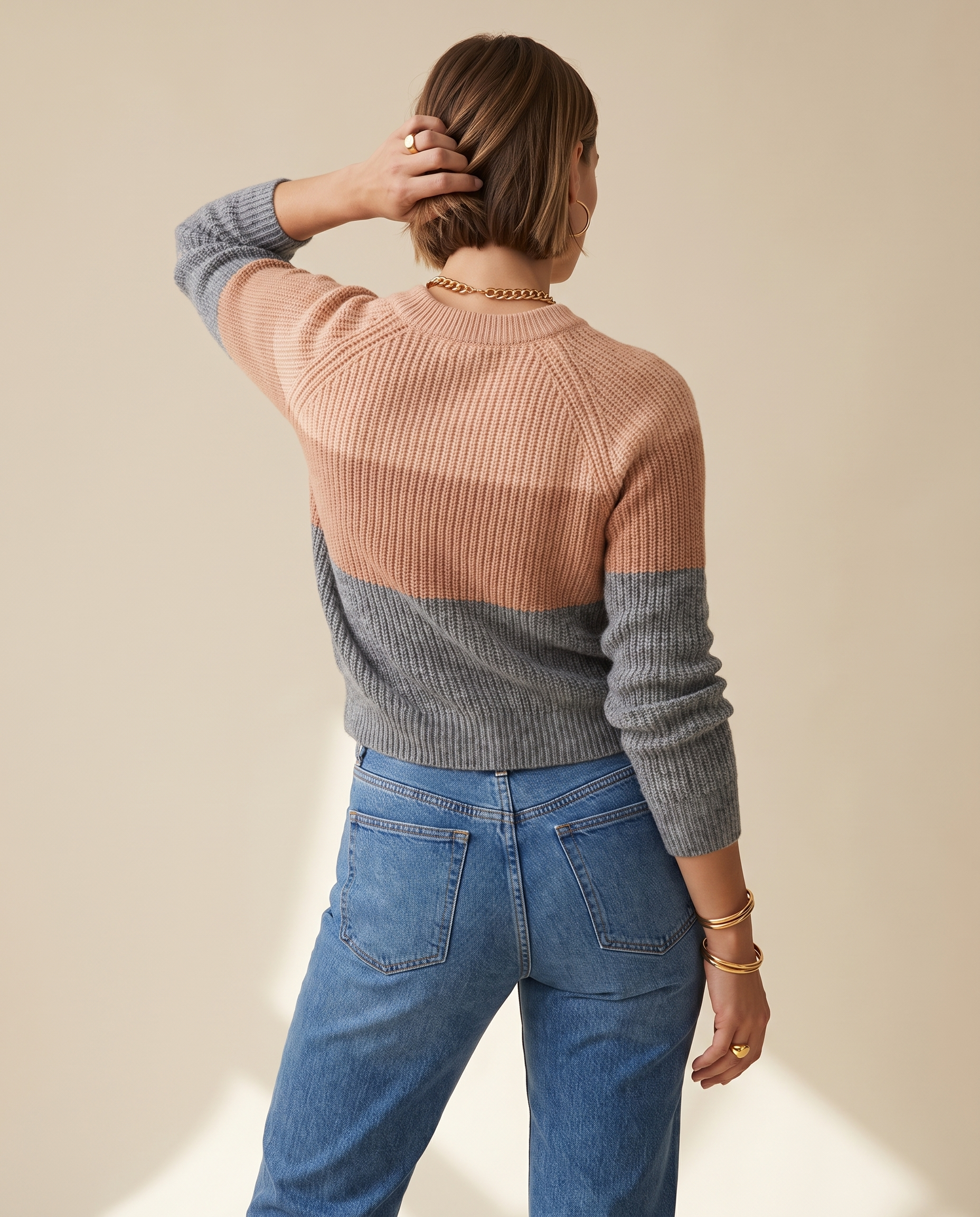 Three-Tone Roll Neck — back view, on a soft oat-beige studio backdrop
