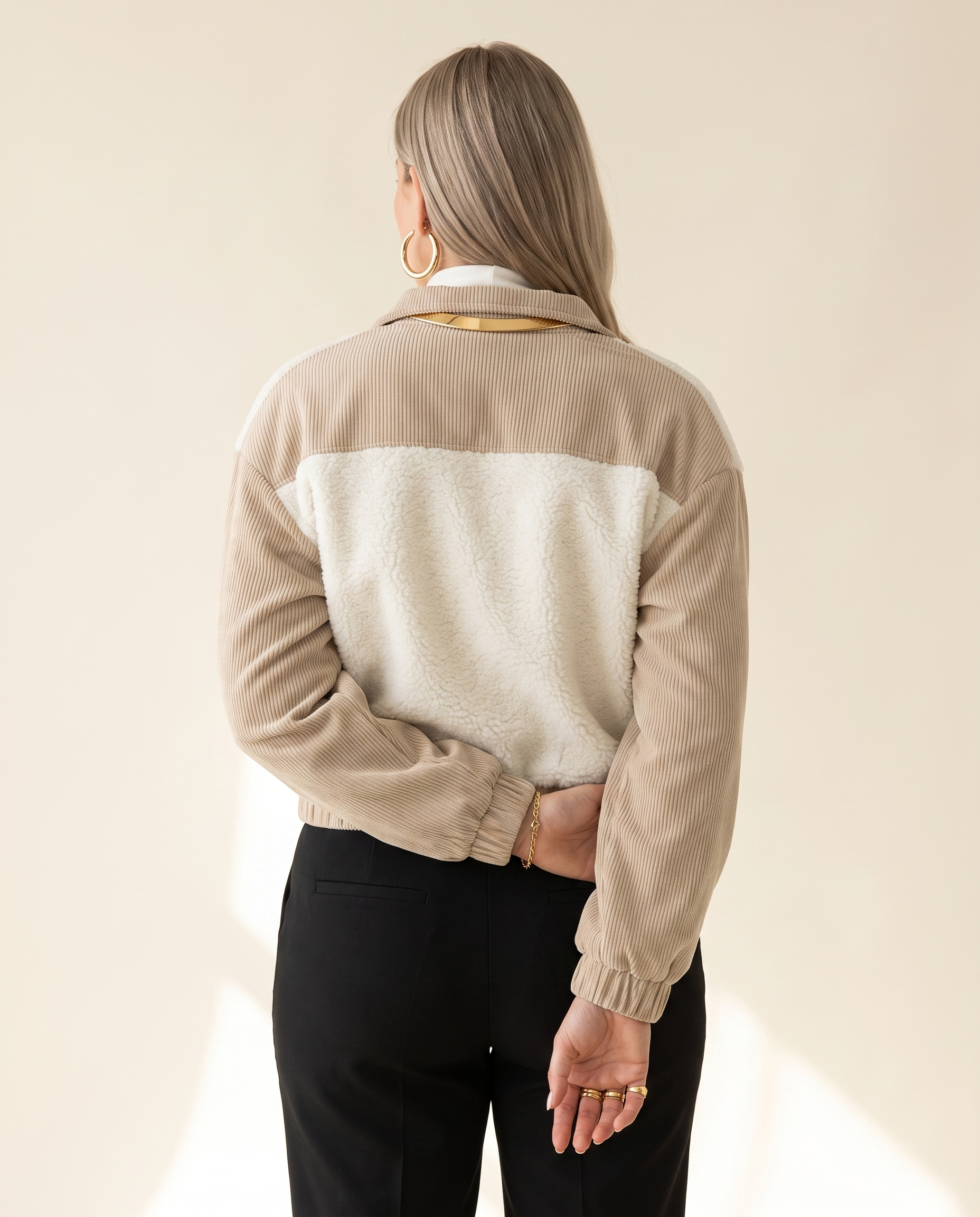 Teddy Panel Jacket — back view, on a warm ivory studio backdrop