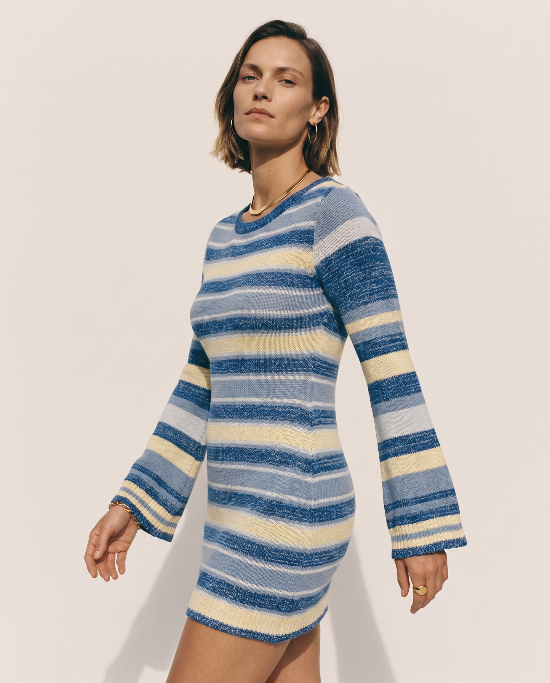 Bell Sleeve Knit Dress — three-quarter view, on a soft off-white studio backdrop