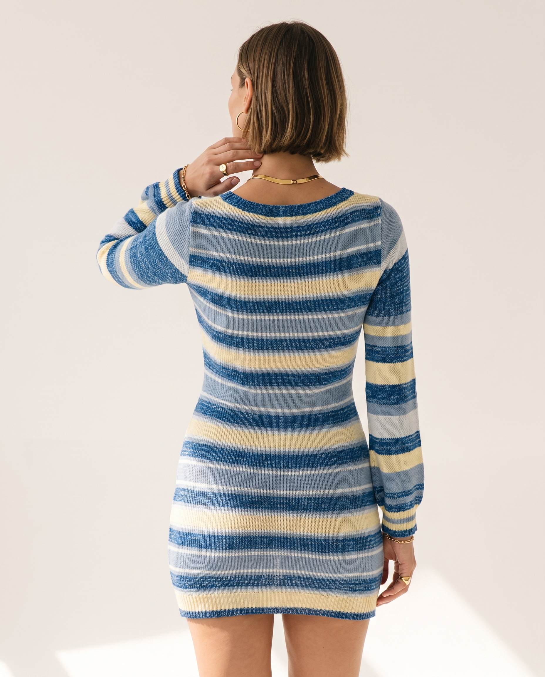 Bell Sleeve Knit Dress — back view, on a soft off-white studio backdrop