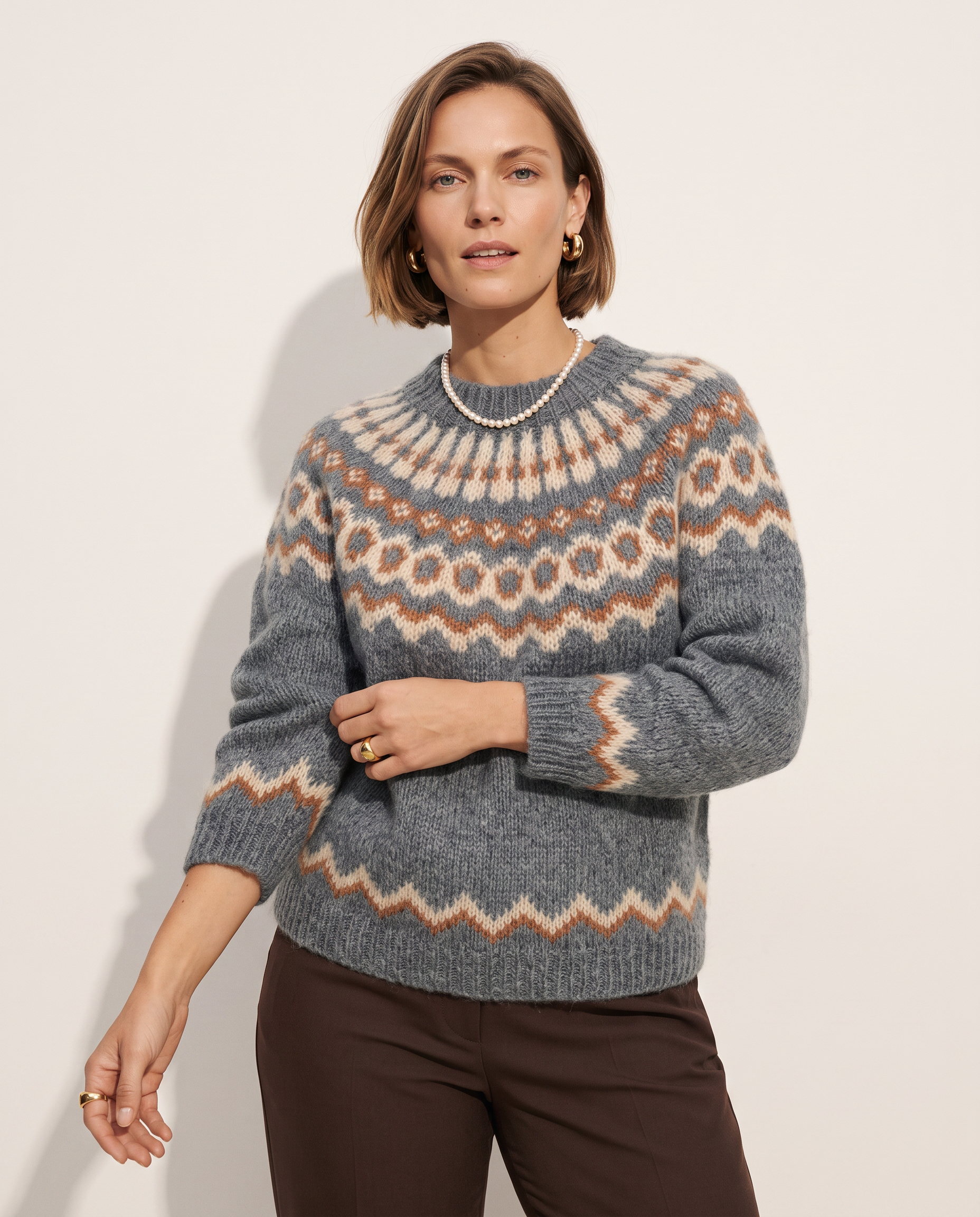 Fair Isle Yoke Sweater — three-quarter view, on a soft off-white studio backdrop