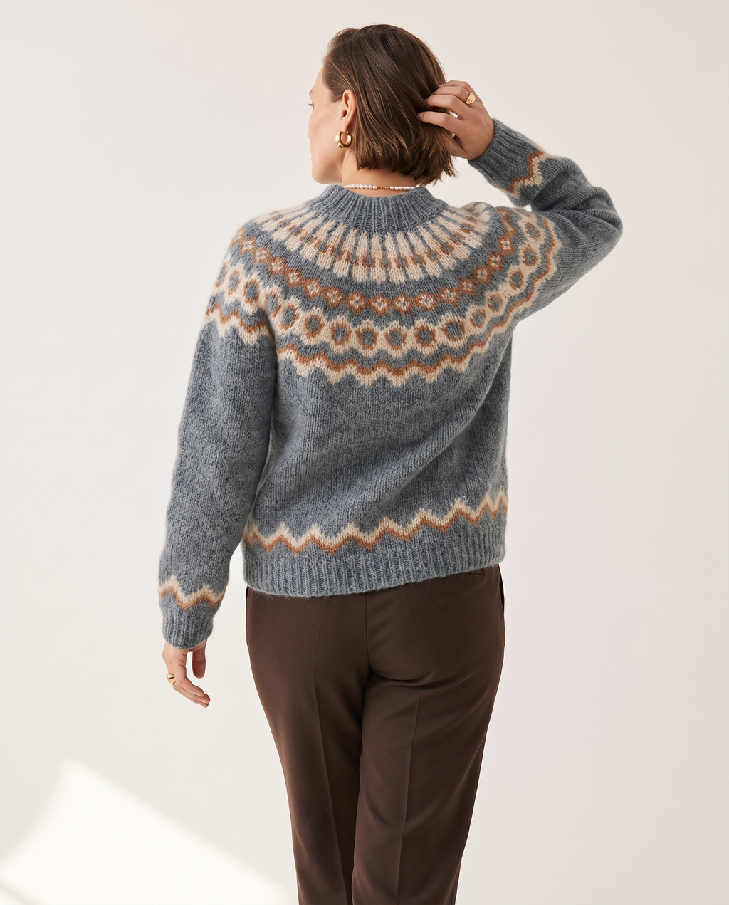 Fair Isle Yoke Sweater — back view, on a soft off-white studio backdrop
