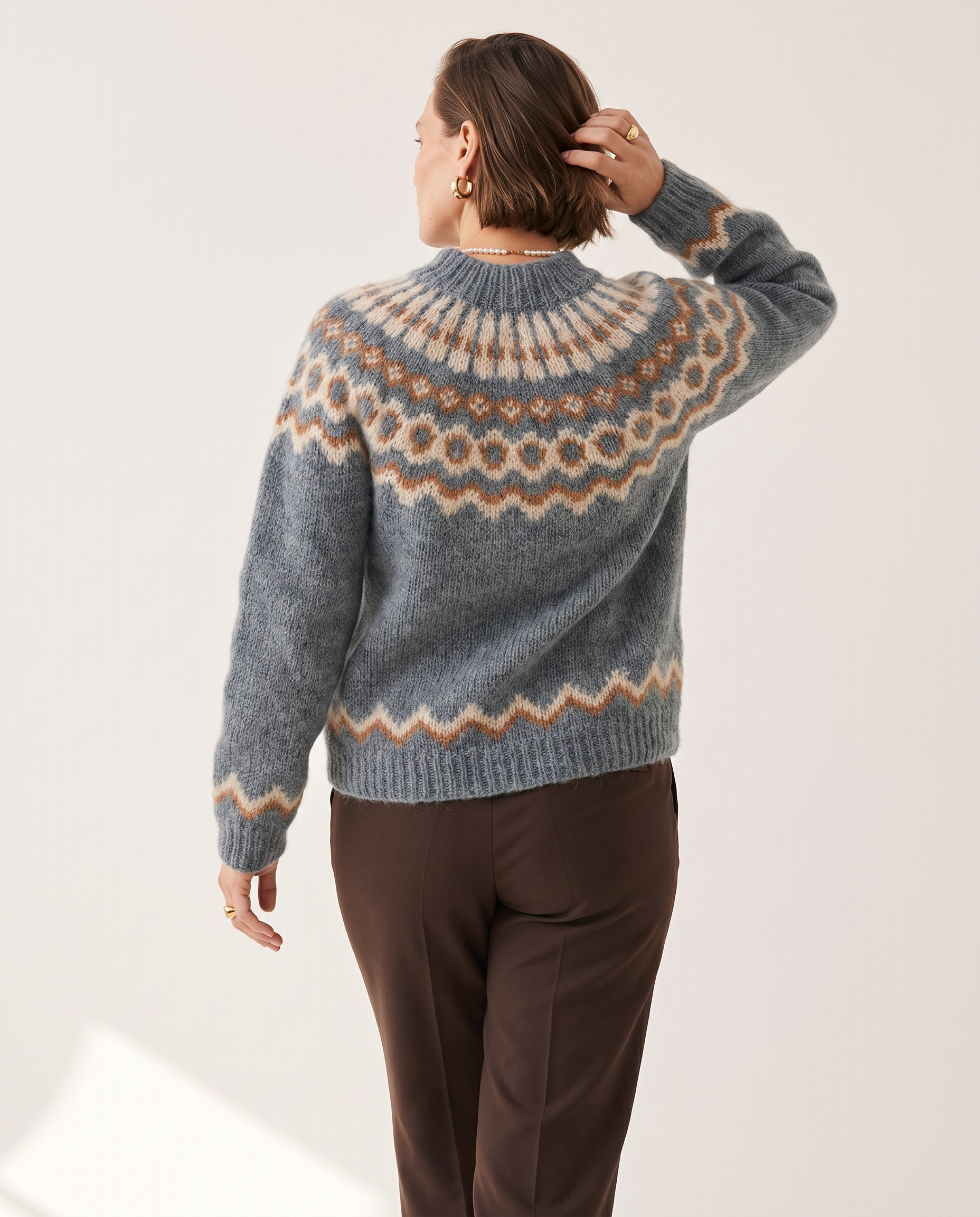 Fair Isle Yoke Sweater — back view, on a soft off-white studio backdrop