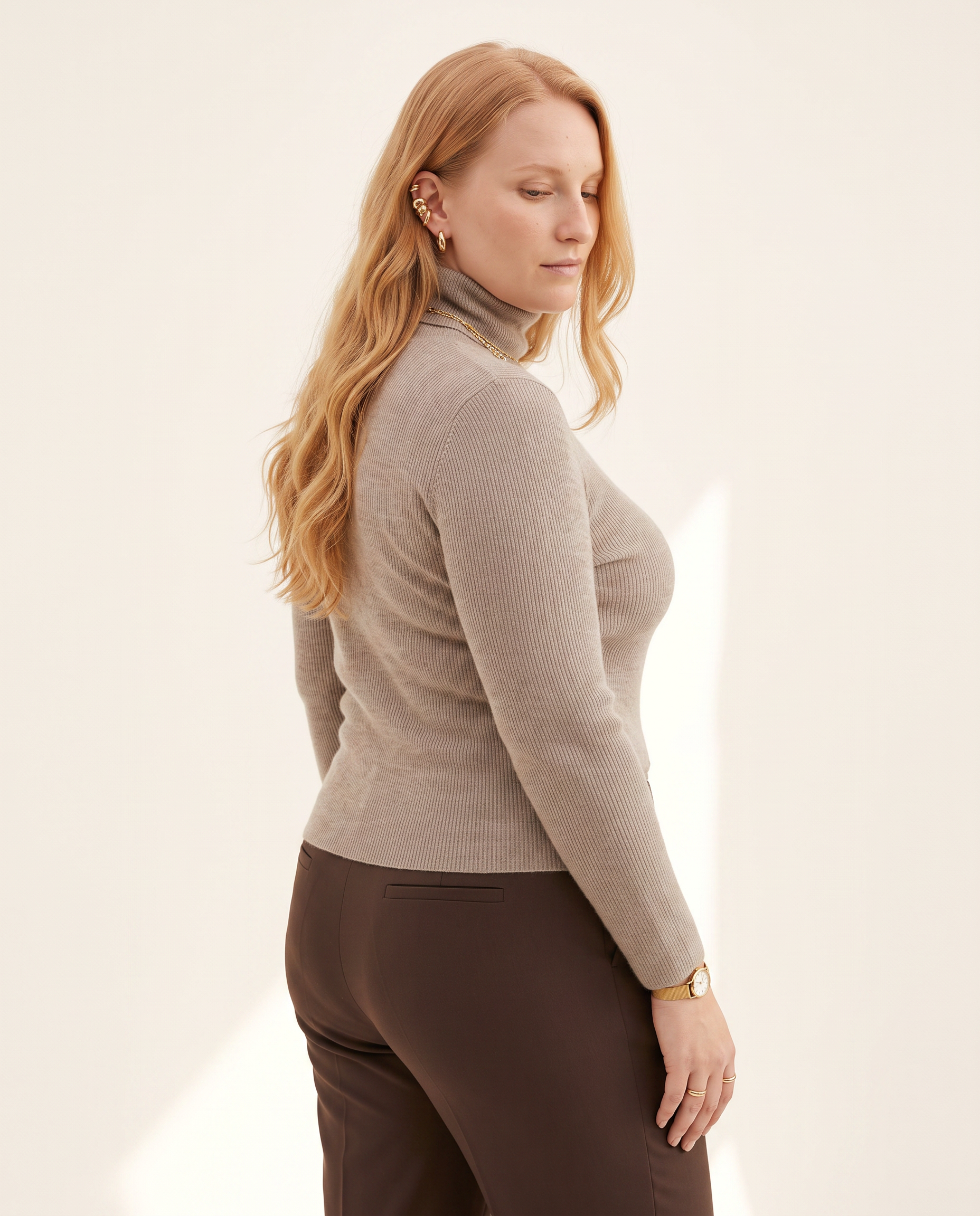 Fine Rib Roll Neck — three-quarter view, on a soft off-white studio backdrop