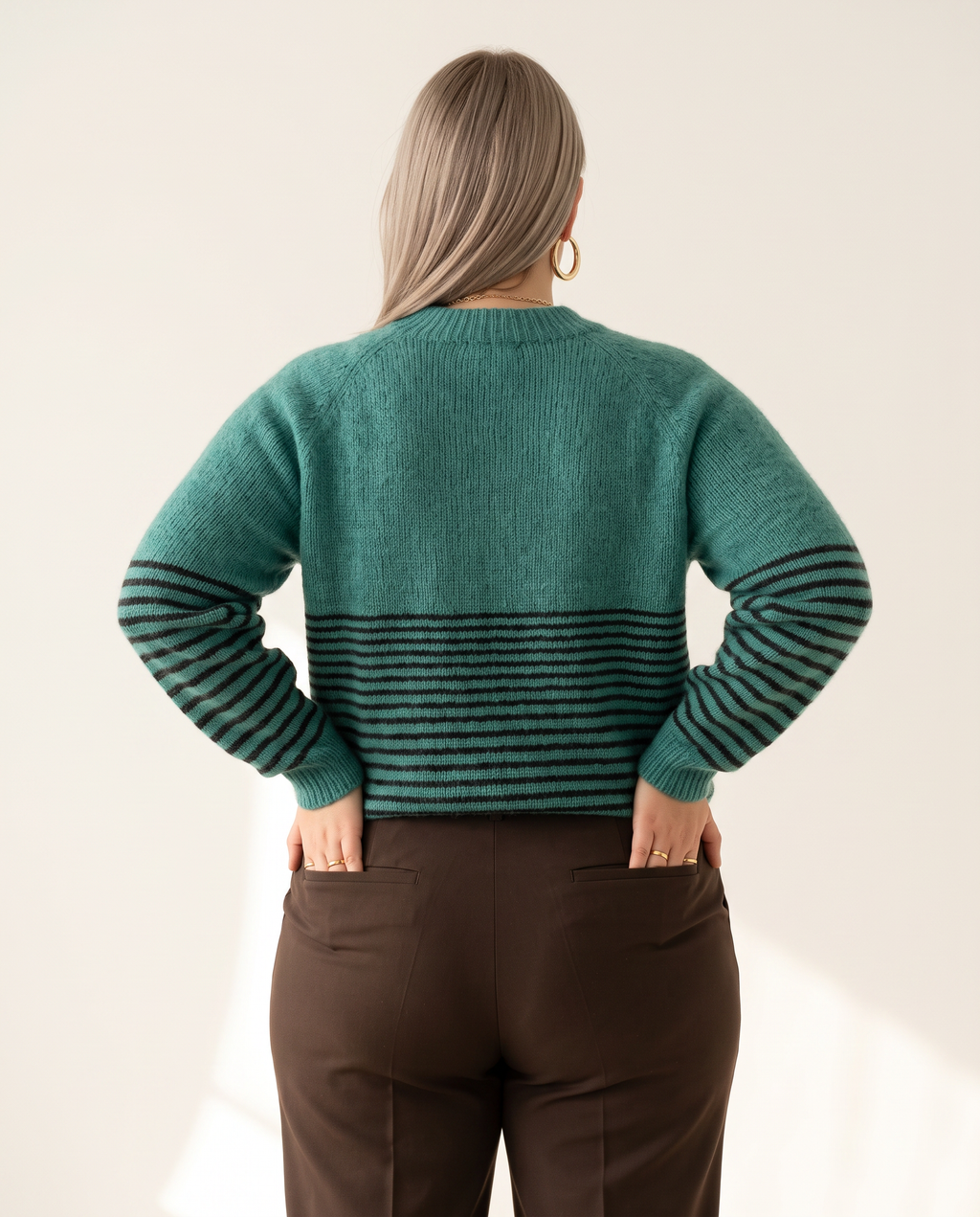Horizon Sweater — back view, on a soft off-white studio backdrop