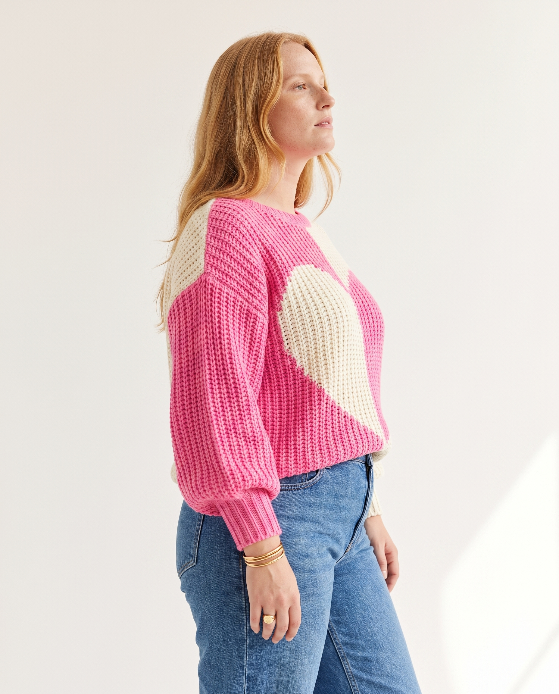 Heart Colourblock Sweater — three-quarter view, on a soft off-white studio backdrop