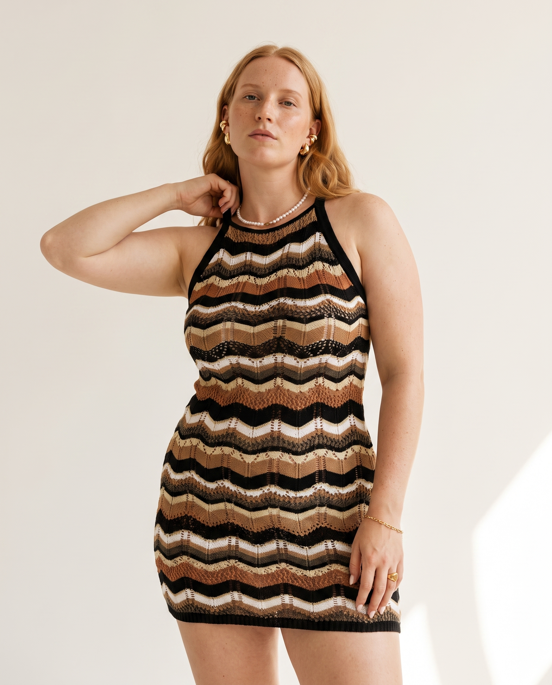 Zigzag Halter Dress — three-quarter view, on a soft off-white studio backdrop