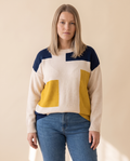 Colourblock Patch Sweater on a pale sand studio backdrop