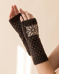 Snowflake Arm Warmers on a pale sand studio backdrop