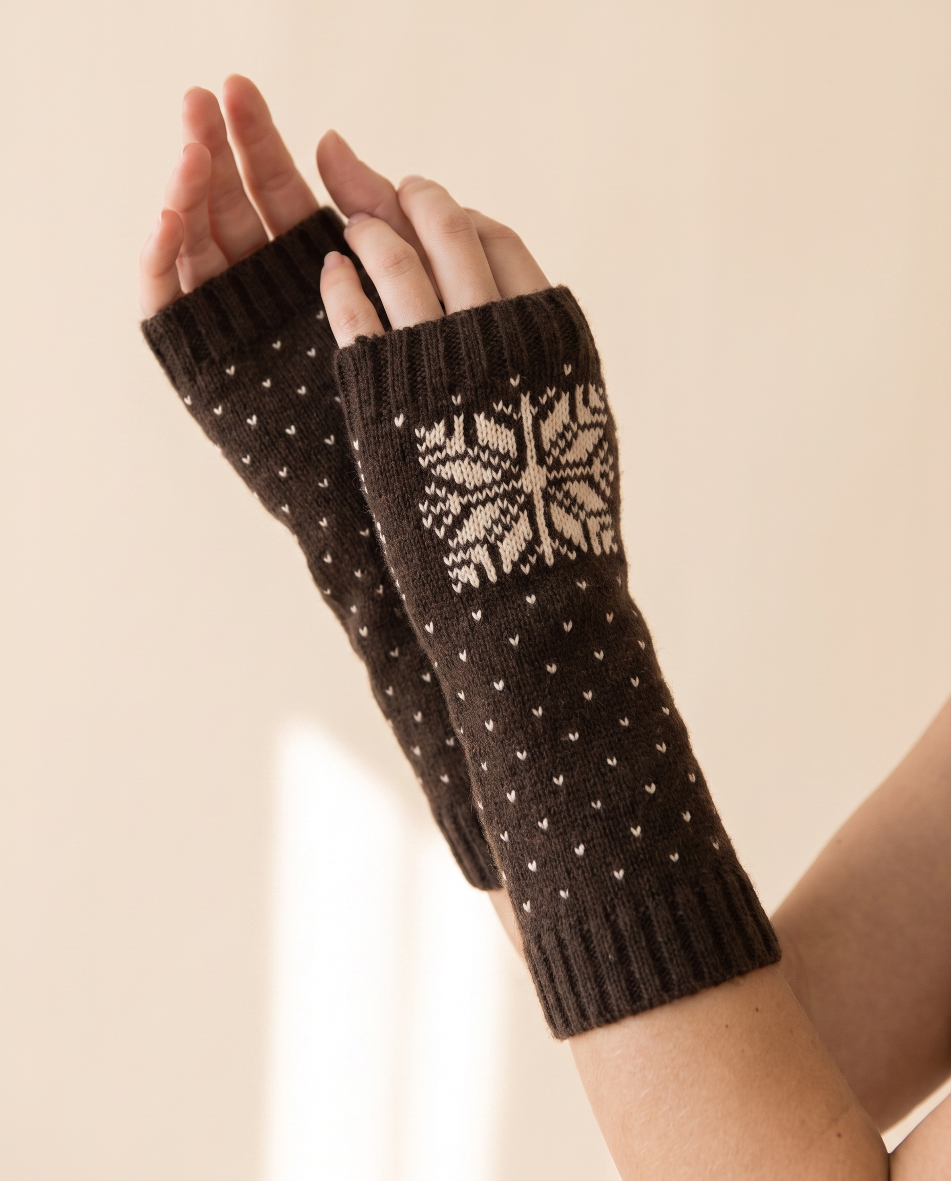 Snowflake Arm Warmers on a pale sand studio backdrop