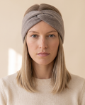 Twist Knit Headband on a pale sand studio backdrop