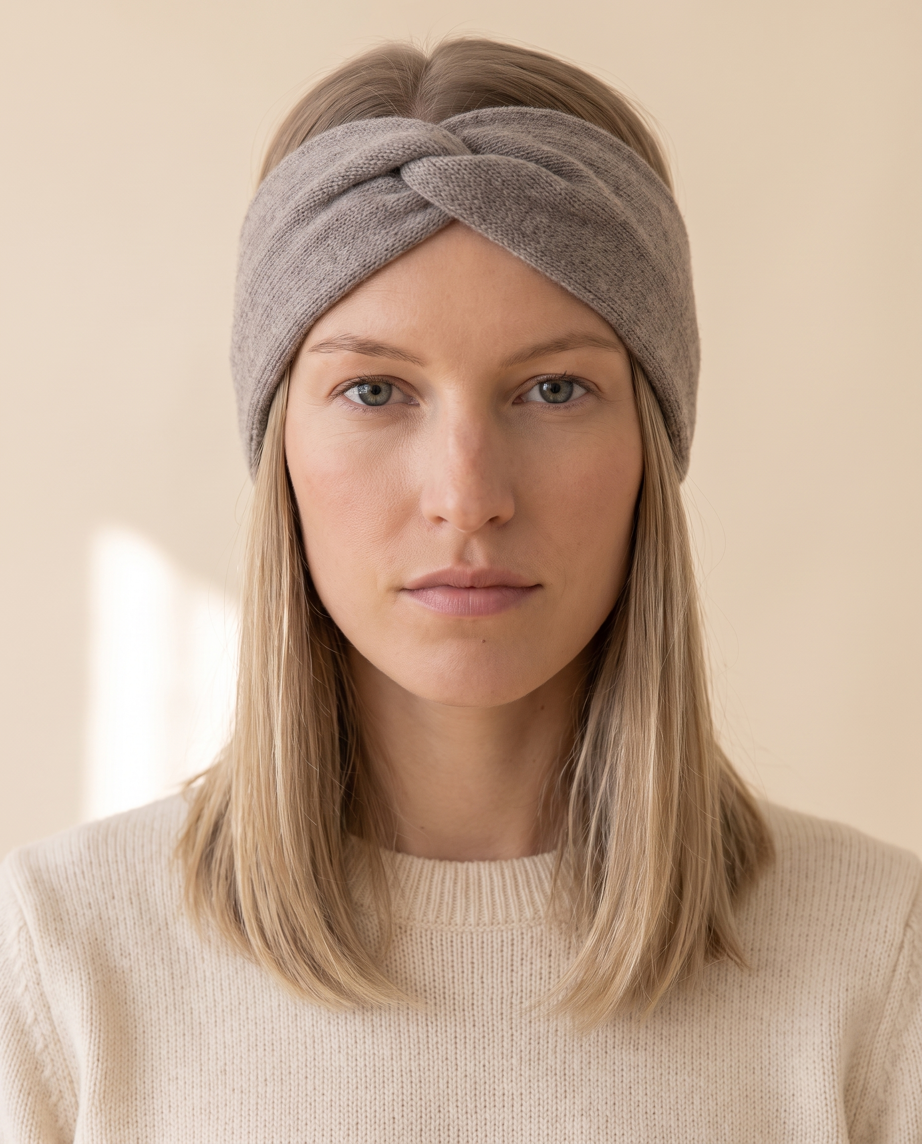 Twist Knit Headband on a pale sand studio backdrop