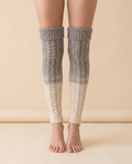 Cable Over-Knee Socks on a pale sand studio backdrop
